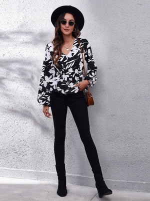 Black butterfly print peplum blouse with gathered waist and V-neck
