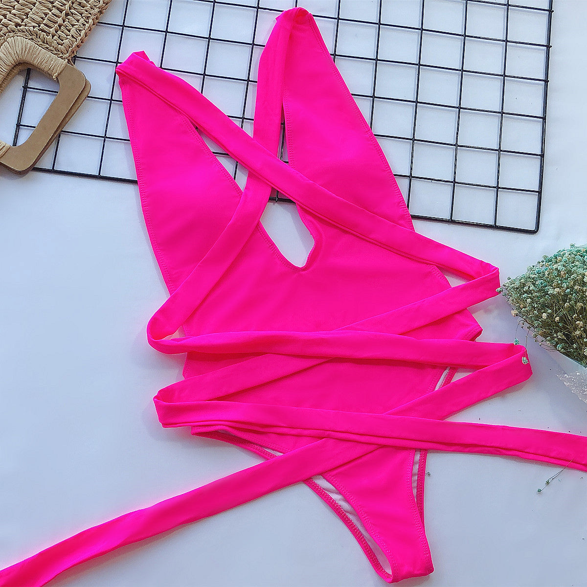 Hot Pink wrap-around halterneck plunge swimsuit with crisscross ties.
