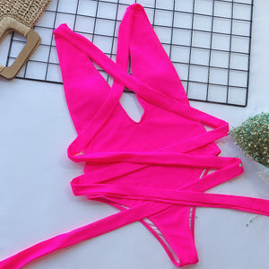 Hot Pink wrap-around halterneck plunge swimsuit with crisscross ties.