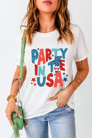 White graphic tee with distressed "PARTY IN THE USA" text print and American flag detail.