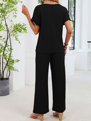 Black lace cutout two-piece set with wide leg pants and short sleeve top