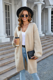 Khaki slouchy knit cardigan with pockets, V-neck, long sleeves, and ribbed trim.
