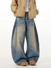 Men's vintage washed oversized wide leg jeans in blue denim with distressed details.