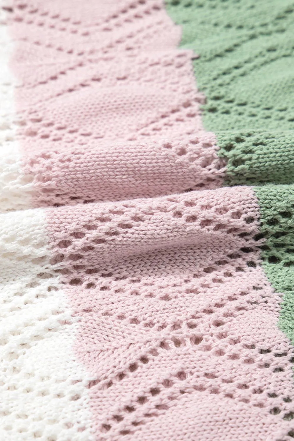 Crochet blouse with stripe pattern in pink, white, and green acrylic, featuring open knit details.