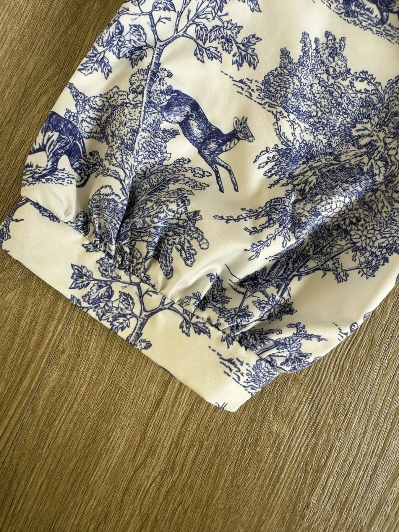White Toile De Jouy half sleeve blouse with blue deer and tree print, featuring a gathered cuff detail.