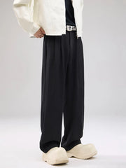 Men's black wide-leg sweatpants with drawstring and pleated front detail.