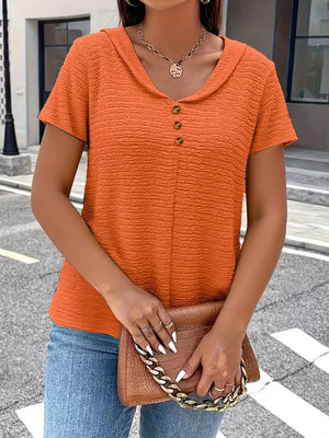 Orange textured short sleeve blouse with button detail and a collared neckline.