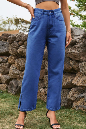Medium wash denim straight leg jeans with cropped length and split hem detail.