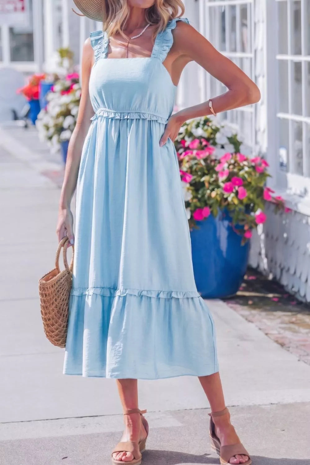 Light blue ruffle-trimmed maternity dress with square neckline and tiered skirt.