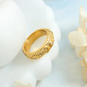 Gold titanium band ring with celestial engraving and small diamond accents