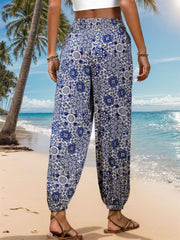Bohemian medallion print harem trousers in dusty blue with elastic waist and cuffs.