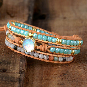 Bohemian wrap bracelet with opal center, multicolor beads, and leather cords.