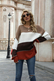 Crewneck knit sweater with color blocking in brown, white, dark brown, and rust orange acrylic.