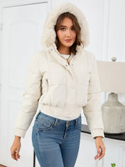 Cream puffer jacket with faux fur trim hood, cinched waist, and zip pockets.