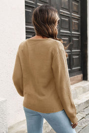 Camel V-neck sweater with vertical ribbing detail on sleeves and hem.