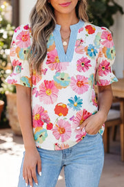 Vibrant floral print cotton blouse with blue striped V-neck and puff sleeves.