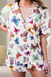 White butterfly print pajama set with short sleeves and a collared neckline.