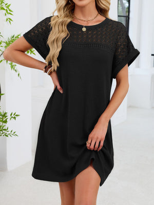 Black t-shirt dress with sheer lace yoke and short sleeves, above the knee length.