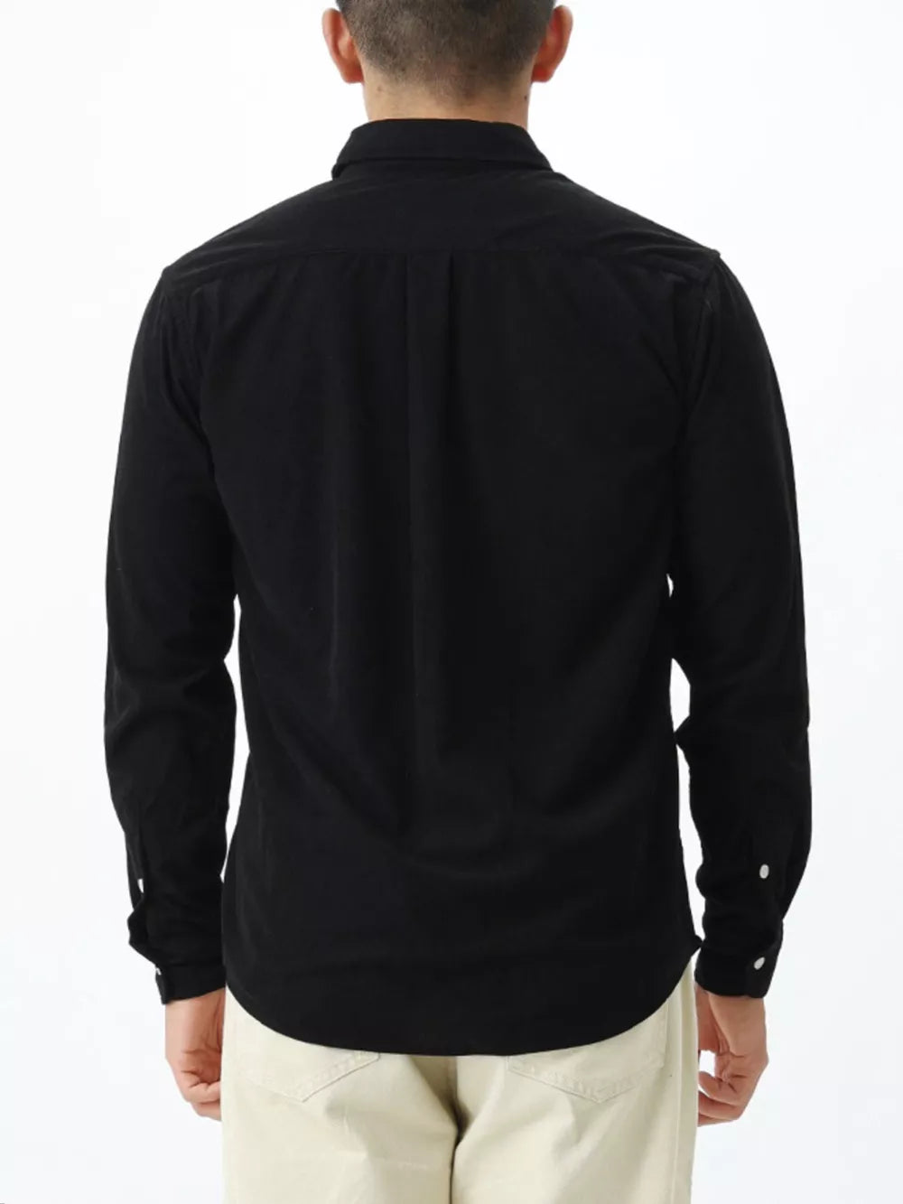 Black long sleeve buttoned shirt with back pleats and buttoned cuffs.