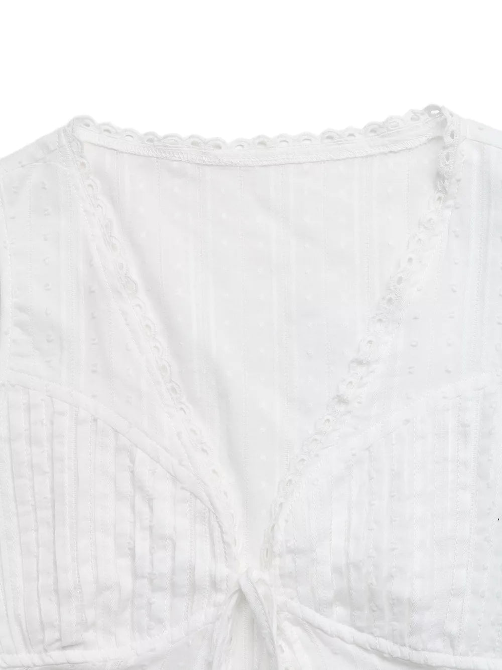 White lace-trimmed tie-front sleeveless maternity blouse with textured fabric and eyelet detail.