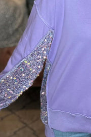 Lavender sweatshirt with sequin panel detail on sleeve and side.