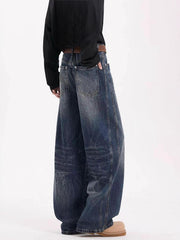 Men's vintage wide leg jeans in dark blue denim with a belted waist and distressed details.