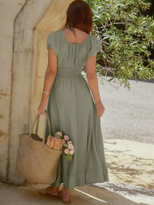 Sage green smocked waist maxi dress with short puff sleeves and a square neckline.