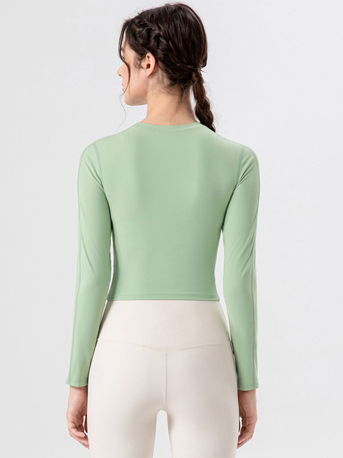 Light Green long sleeve crop top with crew neck and subtle seam details.