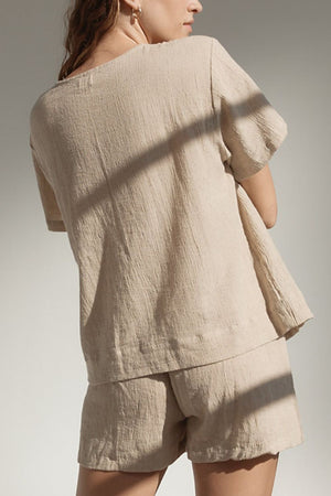 Beige cotton textured short sleeve top and shorts set.