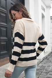 Beige acrylic striped polo sweater with a deep V-neck and long sleeves.