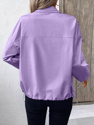 Lavender nylon bomber jacket with drawstring hem and button cuff sleeves.