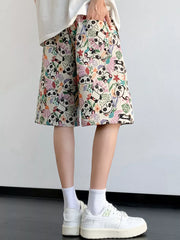 Panda print drawstring shorts in cream with a floral pattern.