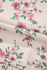 Floral print peplum blouse with square neck in floral pattern on a light background.