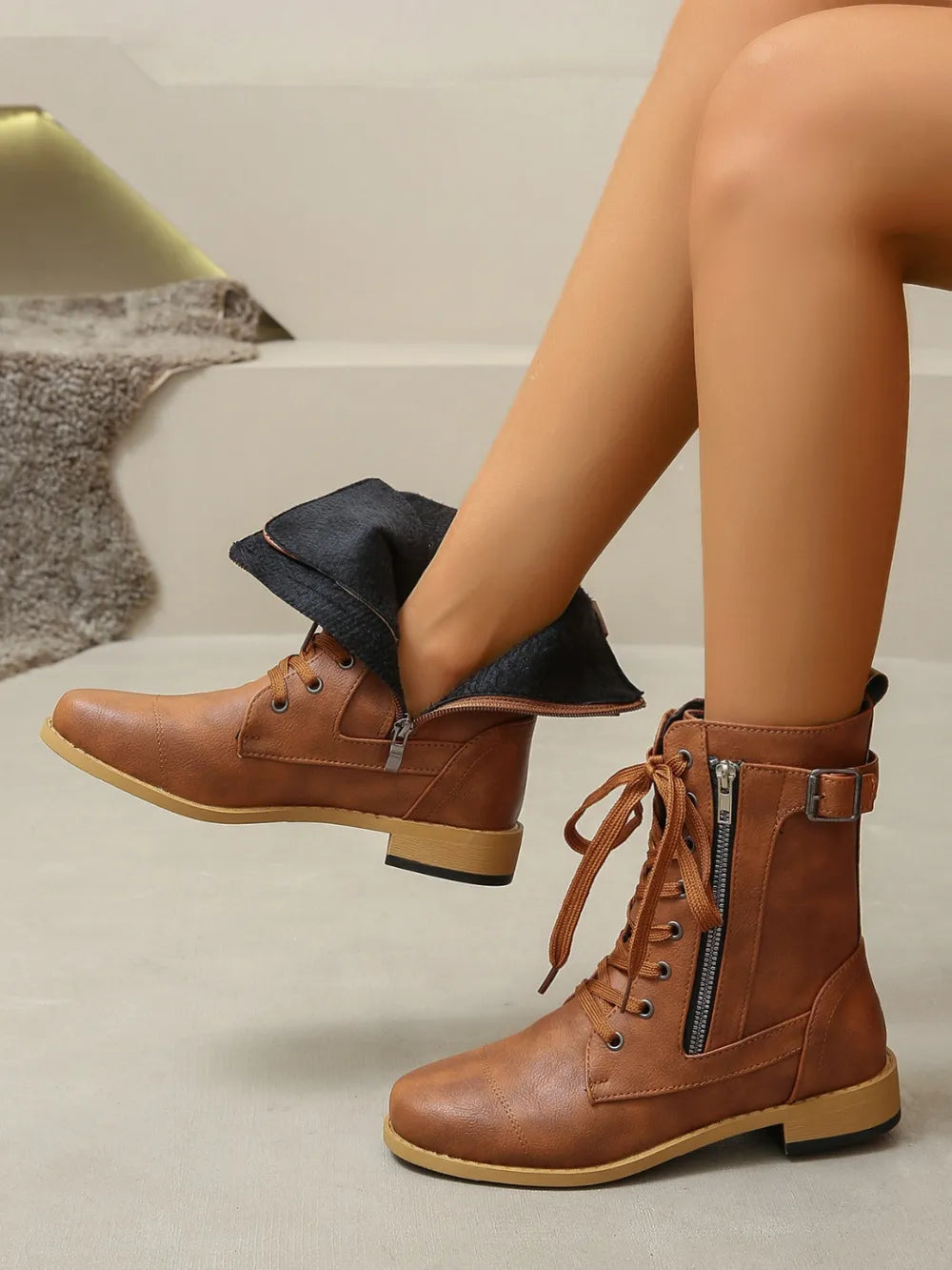 Caramel combat boots with lace-up front and side zipper detail