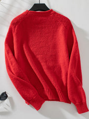 Orange-red acrylic knit sweater with crew neck and ribbed cuffs and hem.