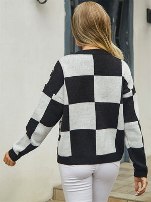 Checkerboard knit cardigan in black and white with long sleeves.