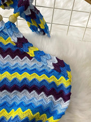 Chevron knit halter crop top with blue, yellow, and purple zig-zag pattern and wooden beads.
