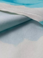 Teal floral print maxi dress detail showing ruffle sleeve fabric texture
