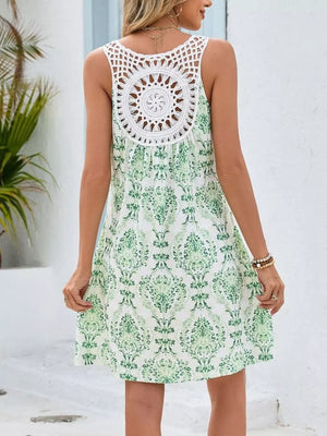 Green Flower botanical print mini dress with crochet detail back and cutout.