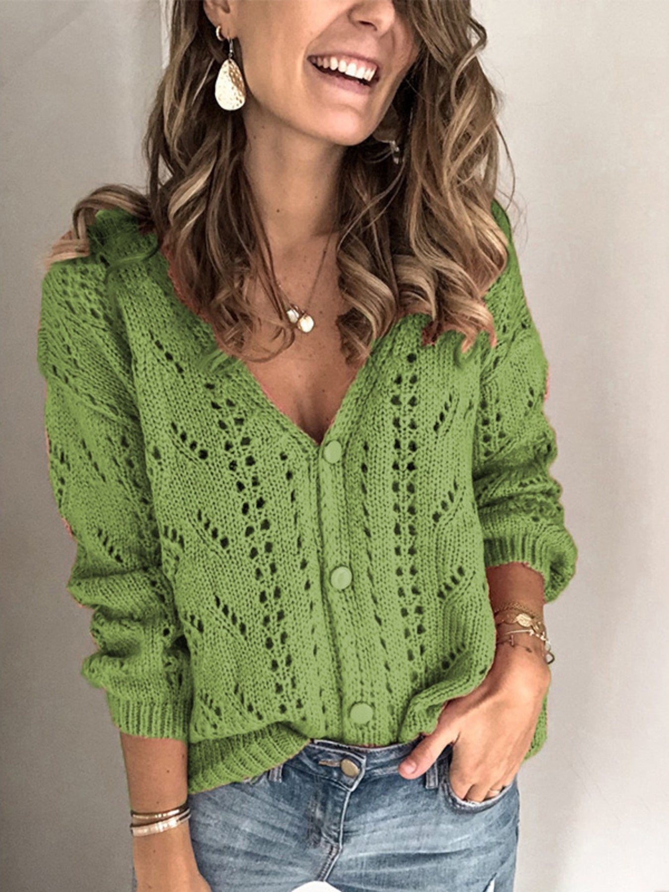 Green chevron knit button-down cardigan with openwork details and matching buttons.