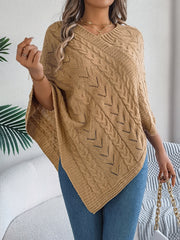 Camel cable knit poncho with chevron detail and V-neck, styled with jeans.