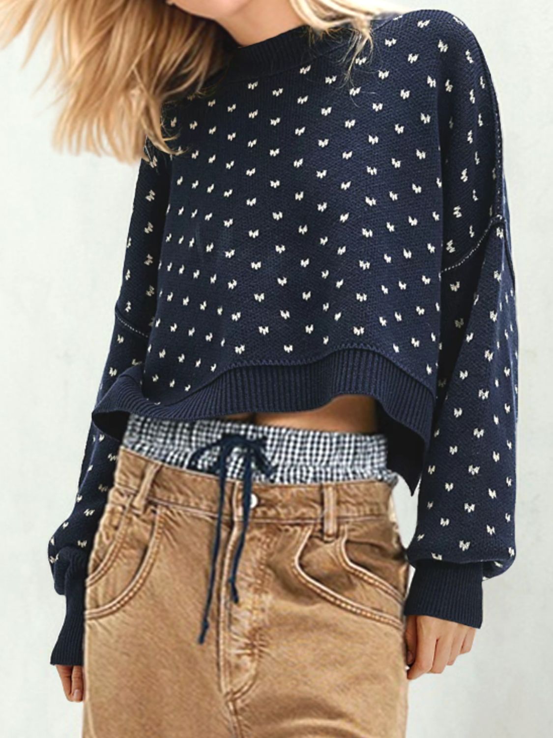 Dotted knit cropped crewneck sweater in dark blue with white pattern, crewneck, long sleeves, and ribbed trim.