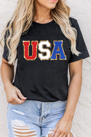 Black t-shirt with glitter USA appliqué in red, white, and blue.