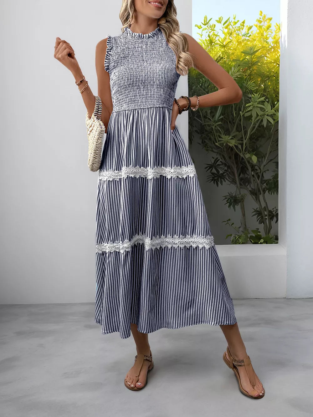 Navy blue striped midi dress with smocked bodice and lace trim.