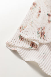 Pleated floral tank top with polka dot print and ruffled hem.