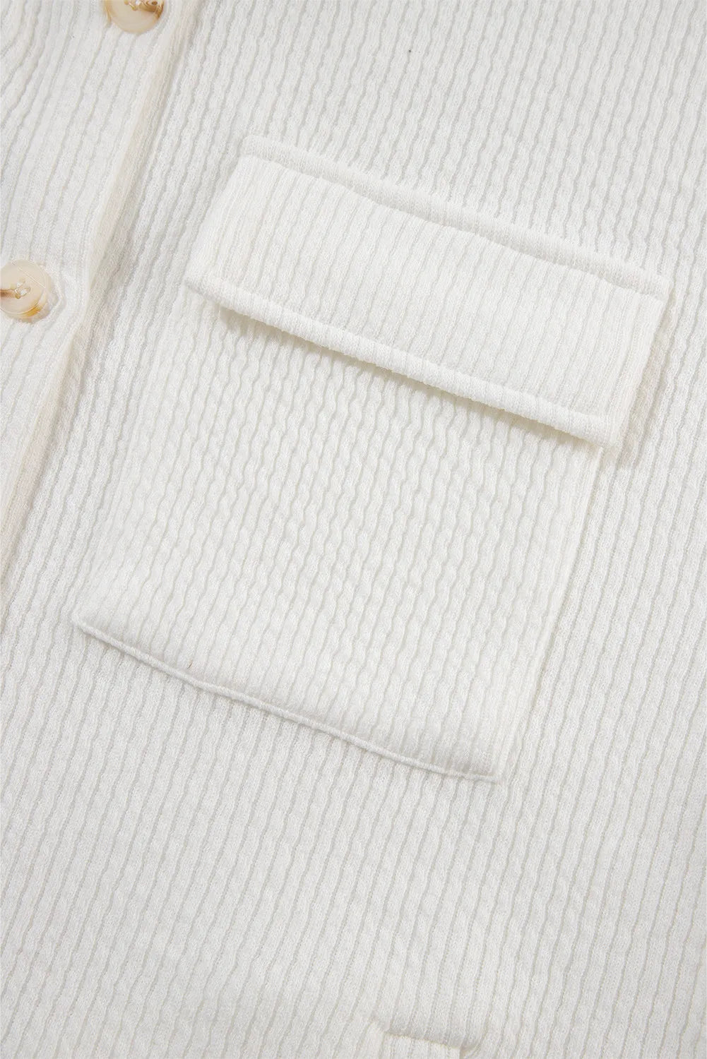White textured corduroy overshirt with patch pocket and button detail.