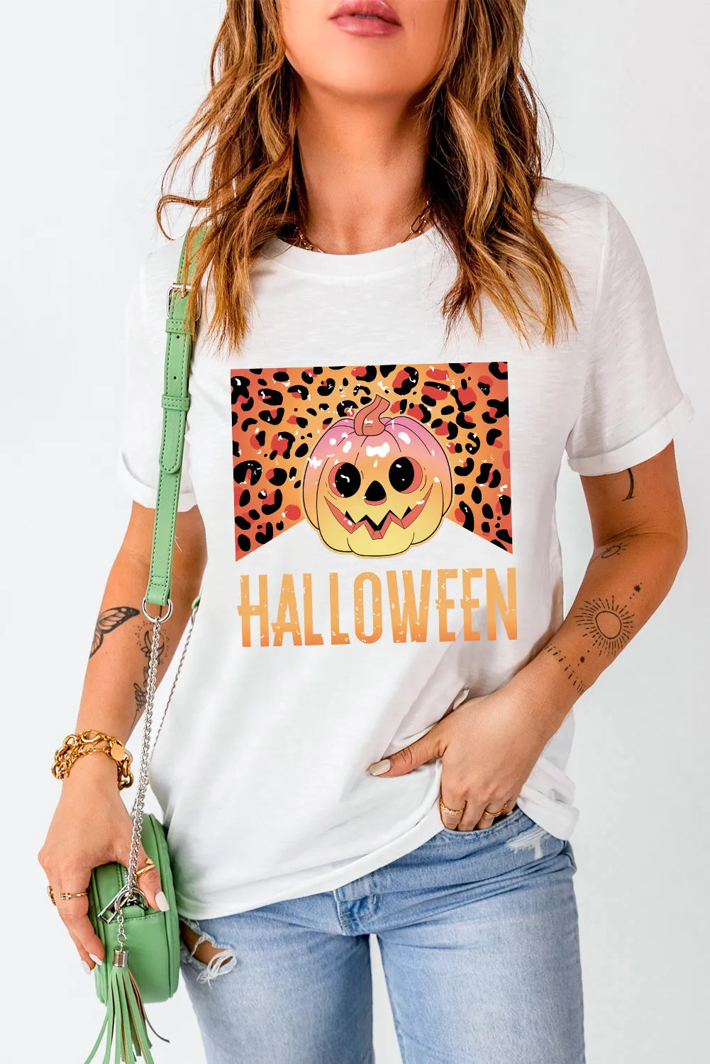 White t-shirt with leopard print pumpkin graphic and Halloween text