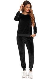 Black velvet lounge set with contrast trim neckline and cuffs. Long sleeve top and cuffed pants.