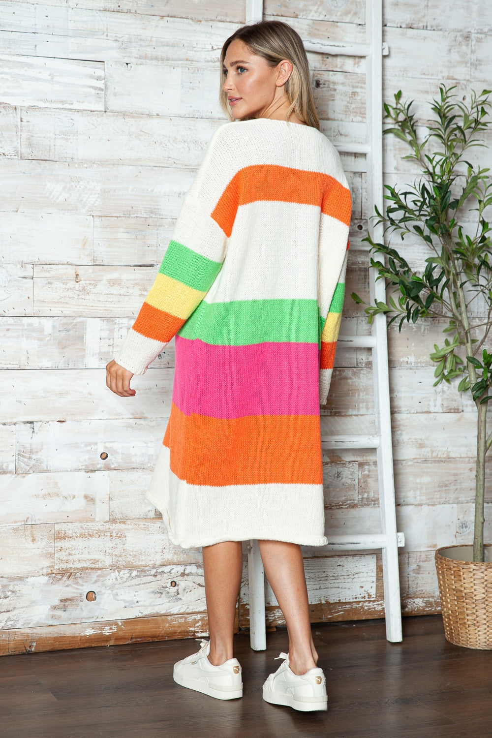 Beige midi sweater dress with rainbow stripes, long sleeves, and crew neck.