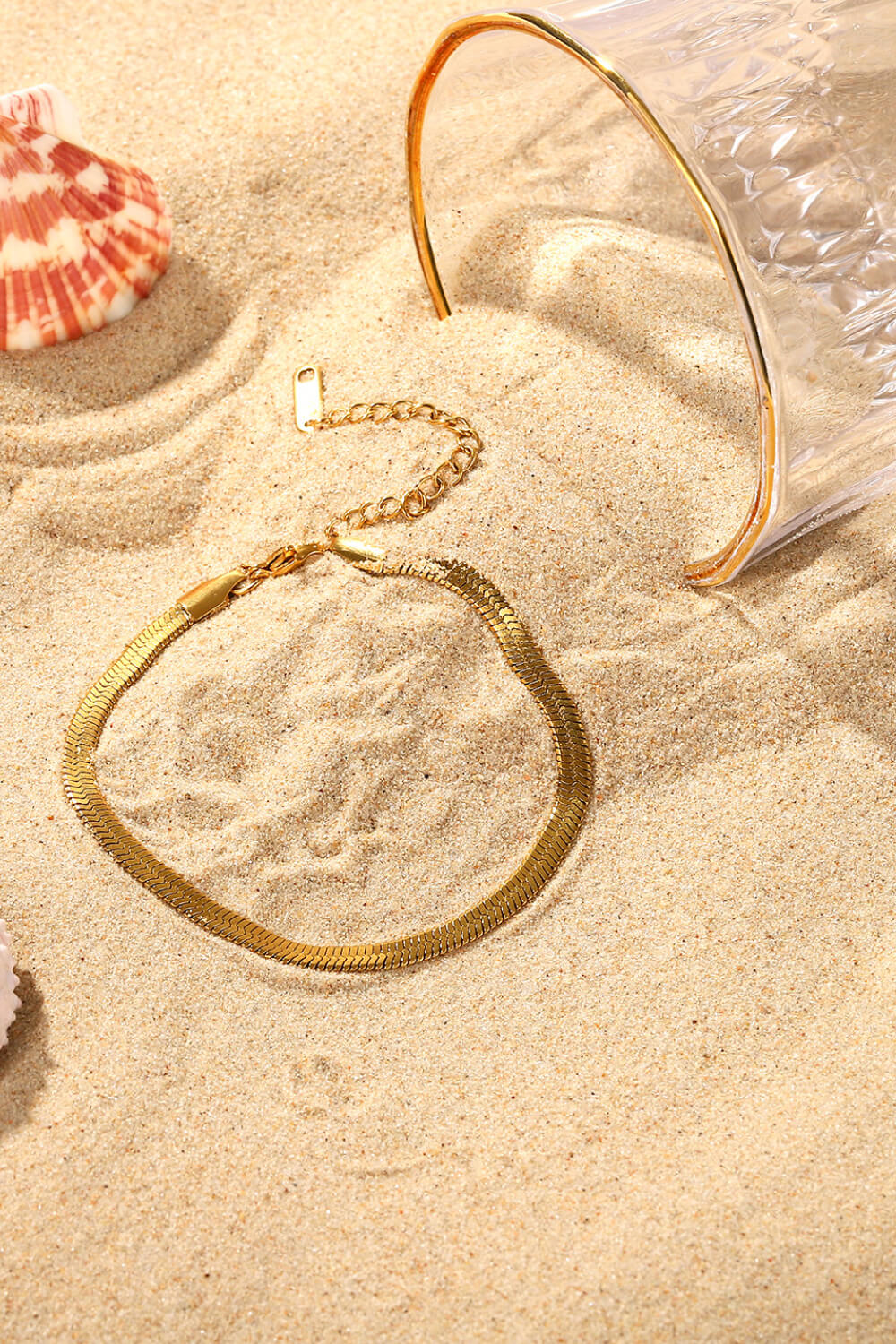 Gold herringbone chain bracelet with adjustable clasp detail.